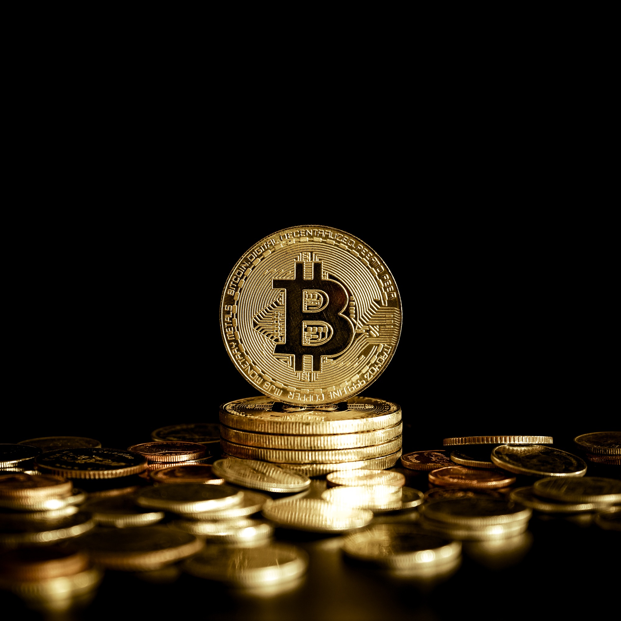 Stack of Bitcoin BTC Cryptocurrency Coins on gold money coin with black background